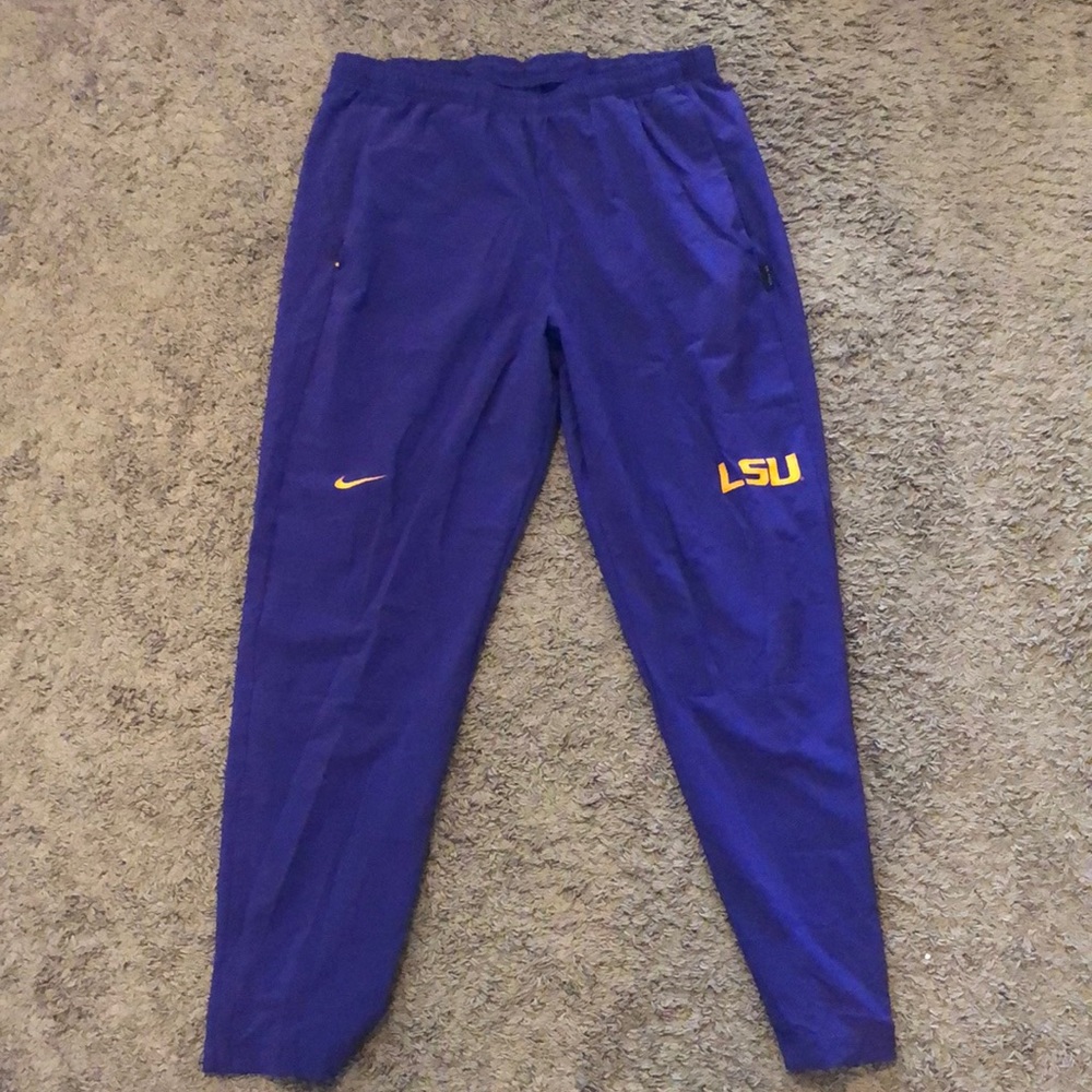 Purple pants with gold LSU logo and Nike sign. Comfortable dri-fit material